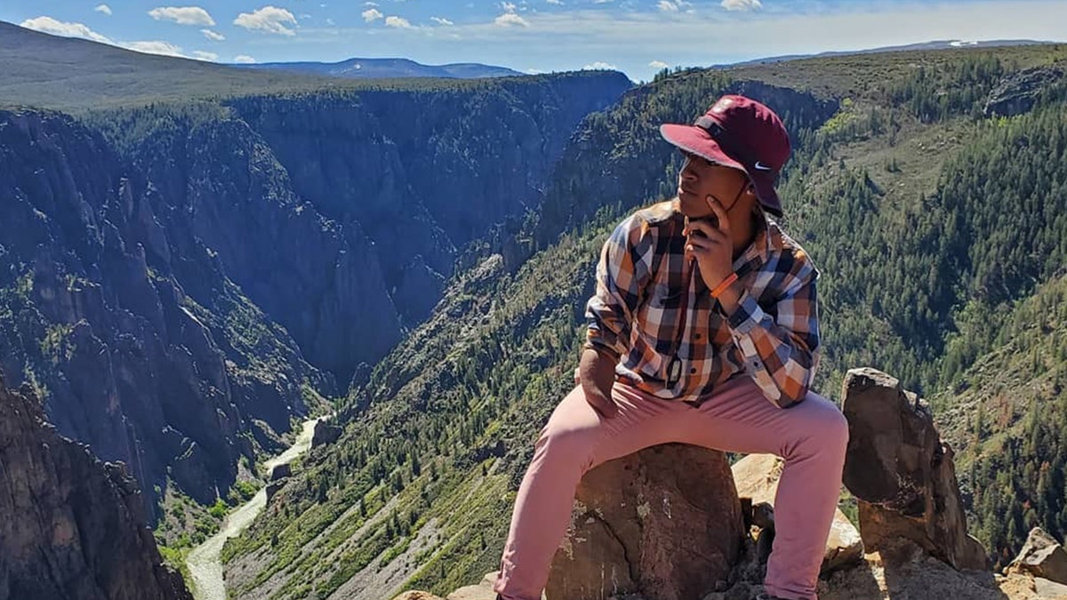 Daniel Robinson sitting on rock