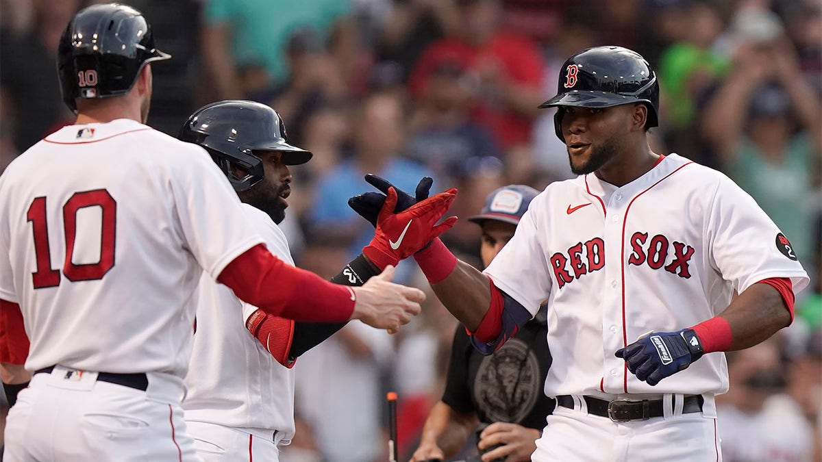 Franchy Cordero celebrates with Jackie Bradley Jr. and Trevor Story