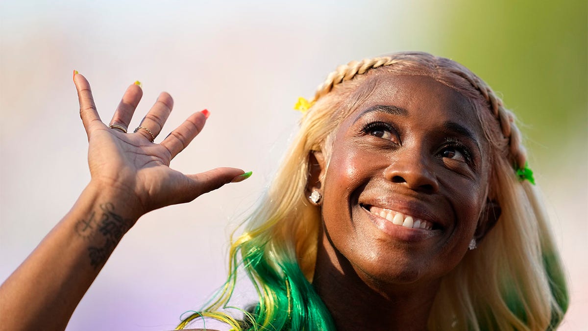 Shelly-Ann Fraser-Pryce waves to crowd