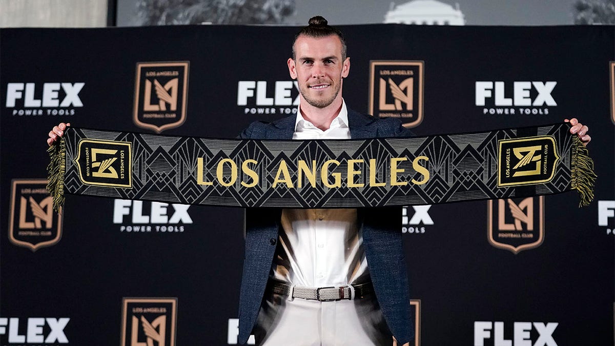 Gareth Bale holds of Los Angeles scarf