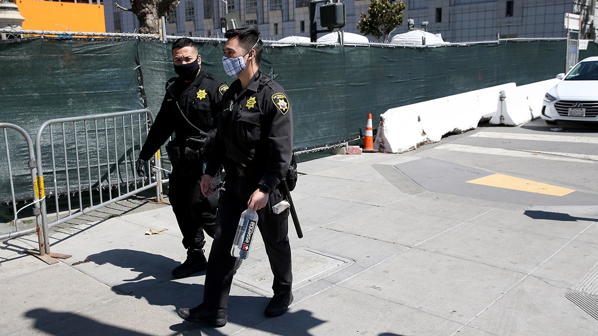 San Francisco officers passing by homeless encampment