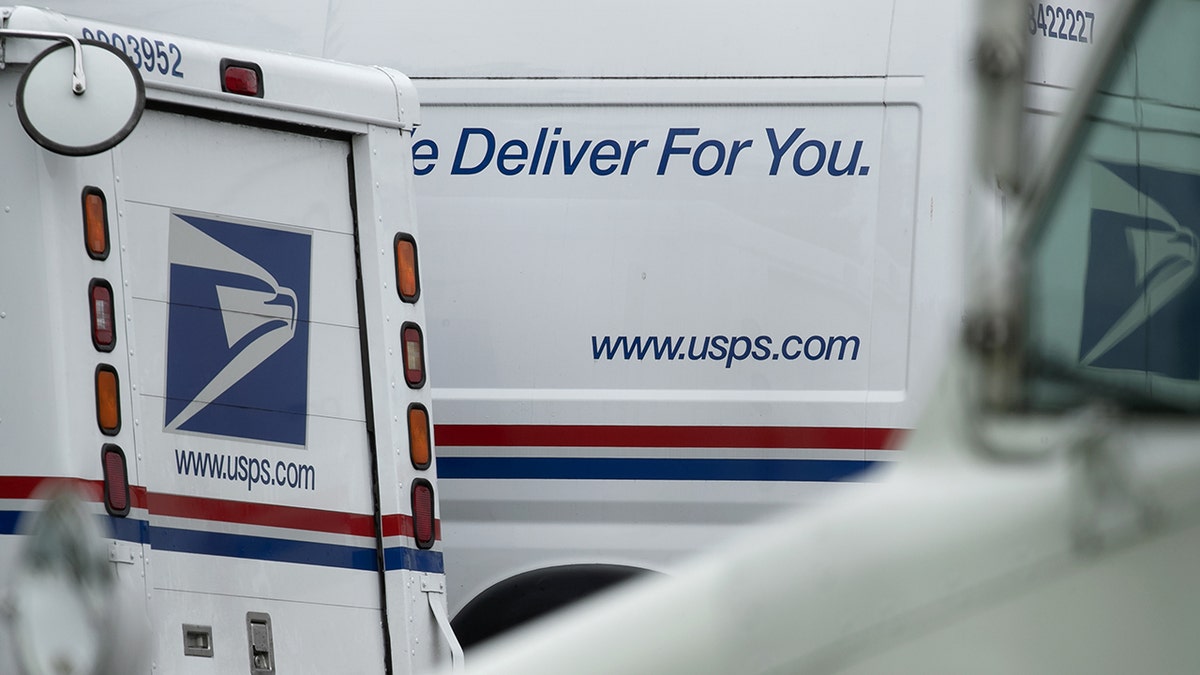 USPS mail trucks in lot
