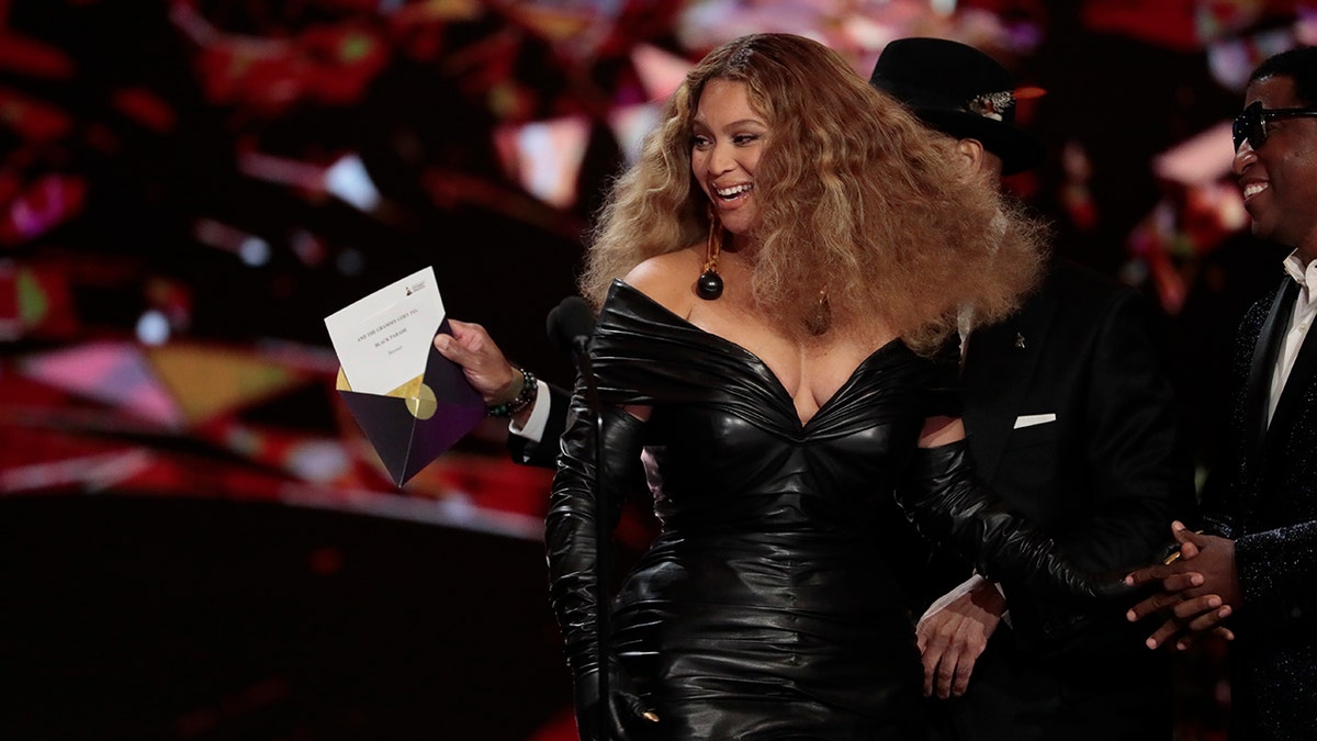 A photo of Beyonce in a black dress accepting an award