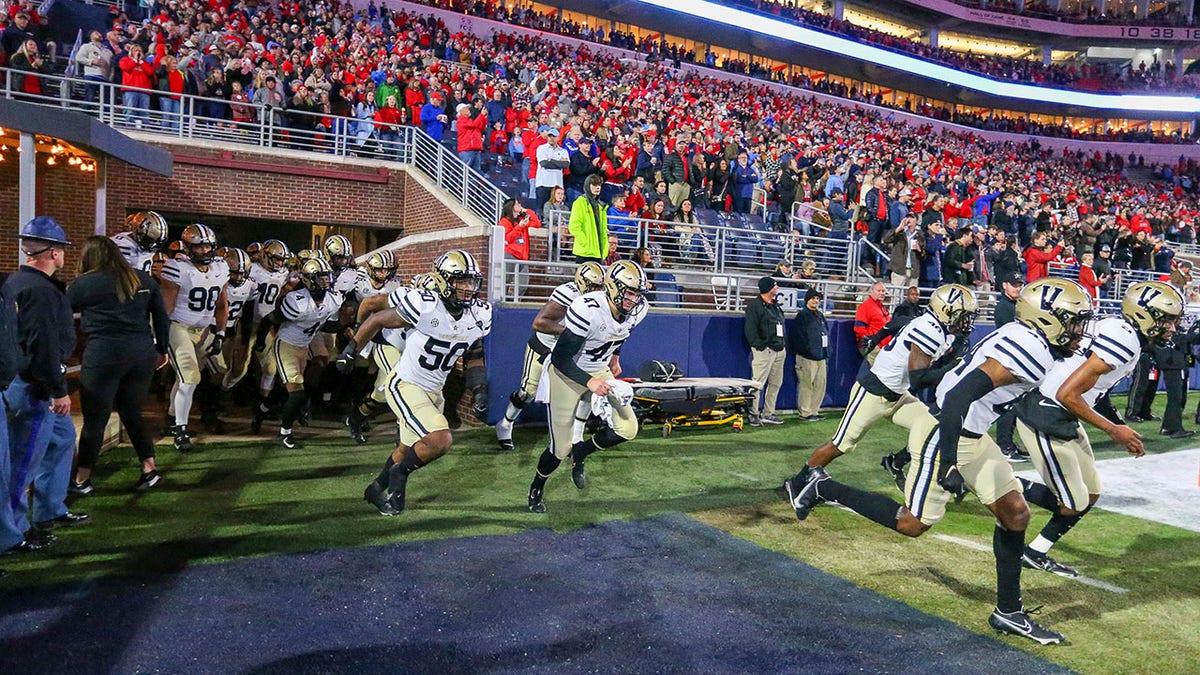 Vanderbilt football runs on the field against Ole Miss