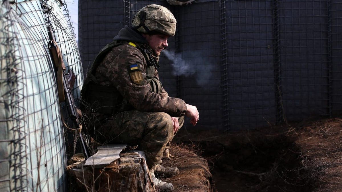 Ukrainian soldier smokes