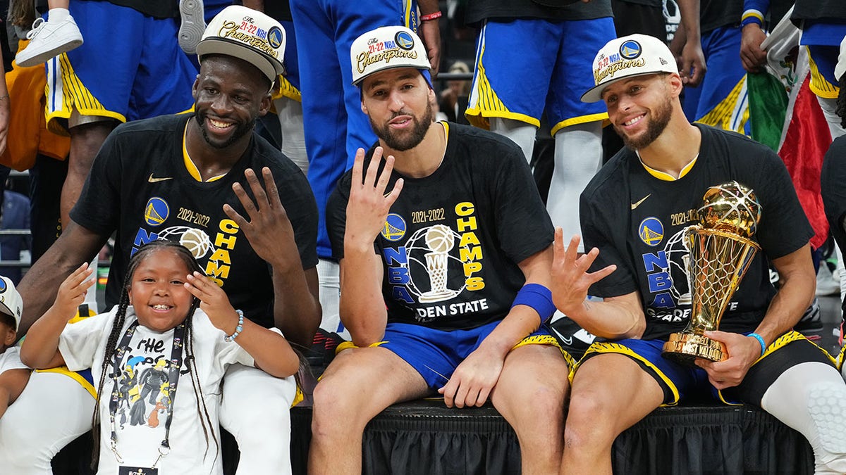 Draymond Green, Klay Thompson and Steph Curry celebrate their fourth championship