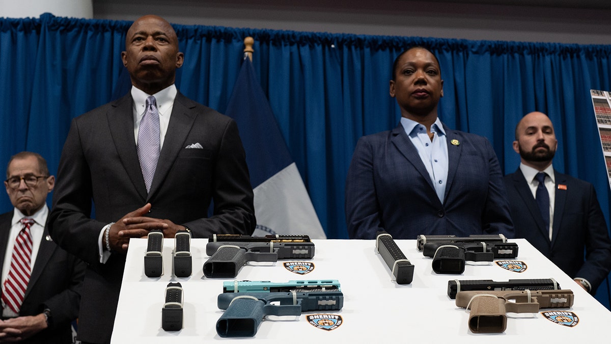 eric adams and nypd commissioner with guns seized