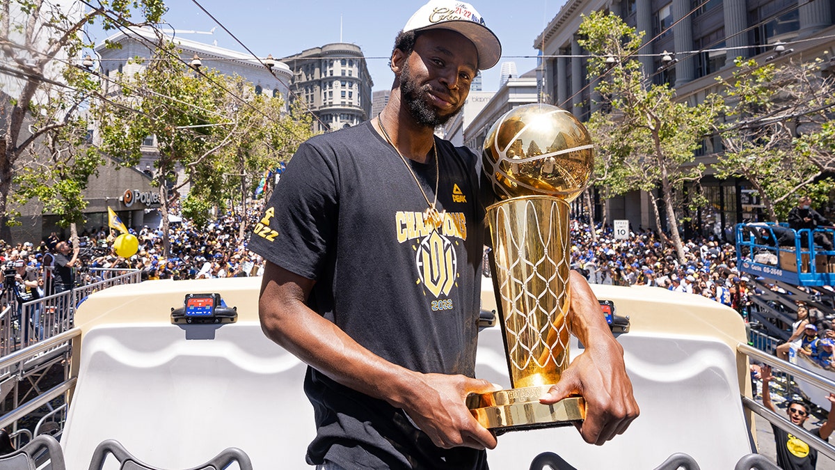 Golden State Warriors' Andrew Wiggins holds the Larry O'Brien Championship Trophy