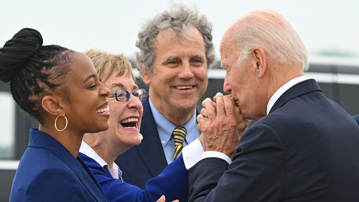 Joe Biden kisses Marcy Kaptur's hand