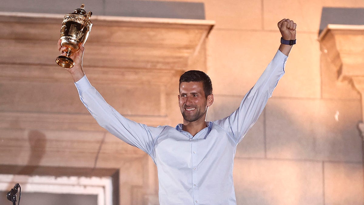 Novak Djokovic celebrates with his seventh Wimbledon trophy