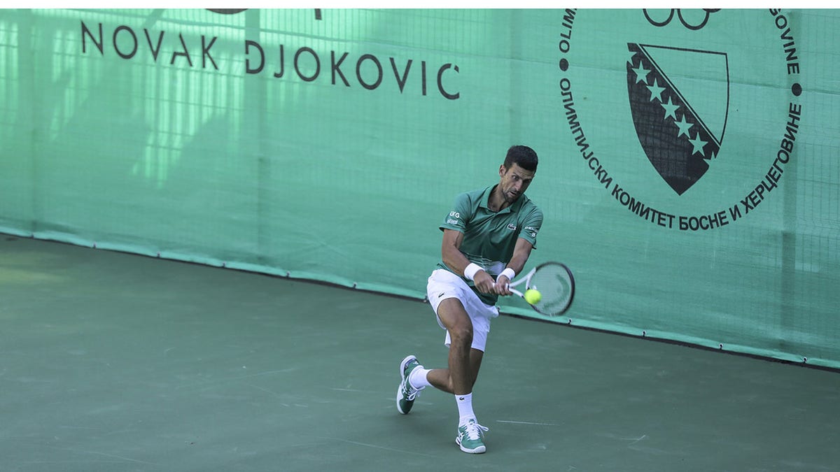 Novak Djokovic plays at the opening ceremony of a new tennis complex