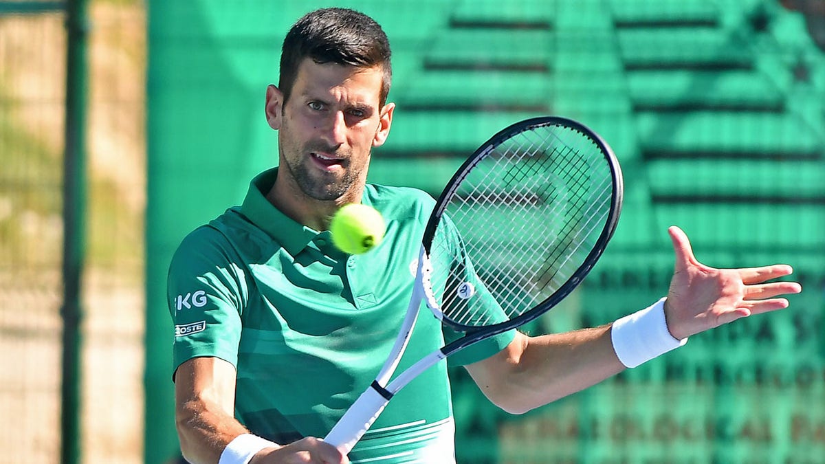 Novak Djokovic returns a ball during an exhibition match