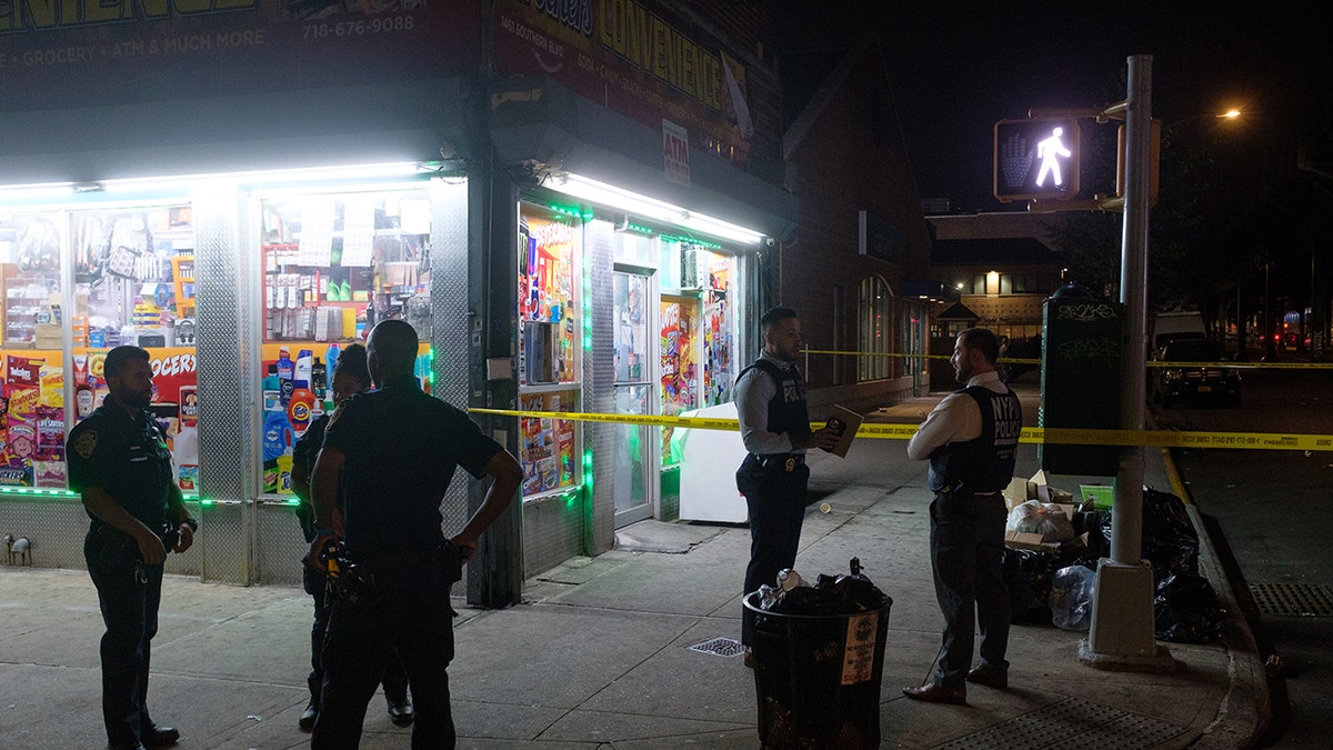 Police officers outside corner store shooting