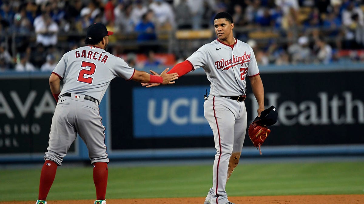 Juan Soto is congradulated after hitting a triple against the Dodgers