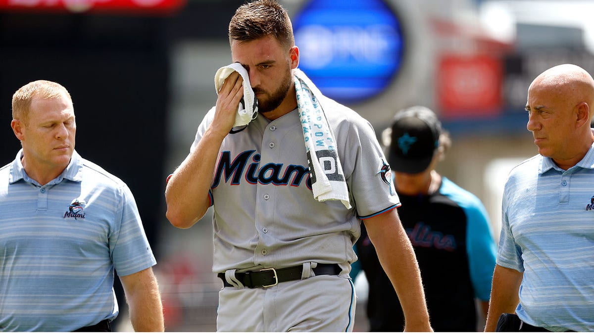 Marlins pitcher Daniel Castano walks off of fiield after being hit in head by line drive
