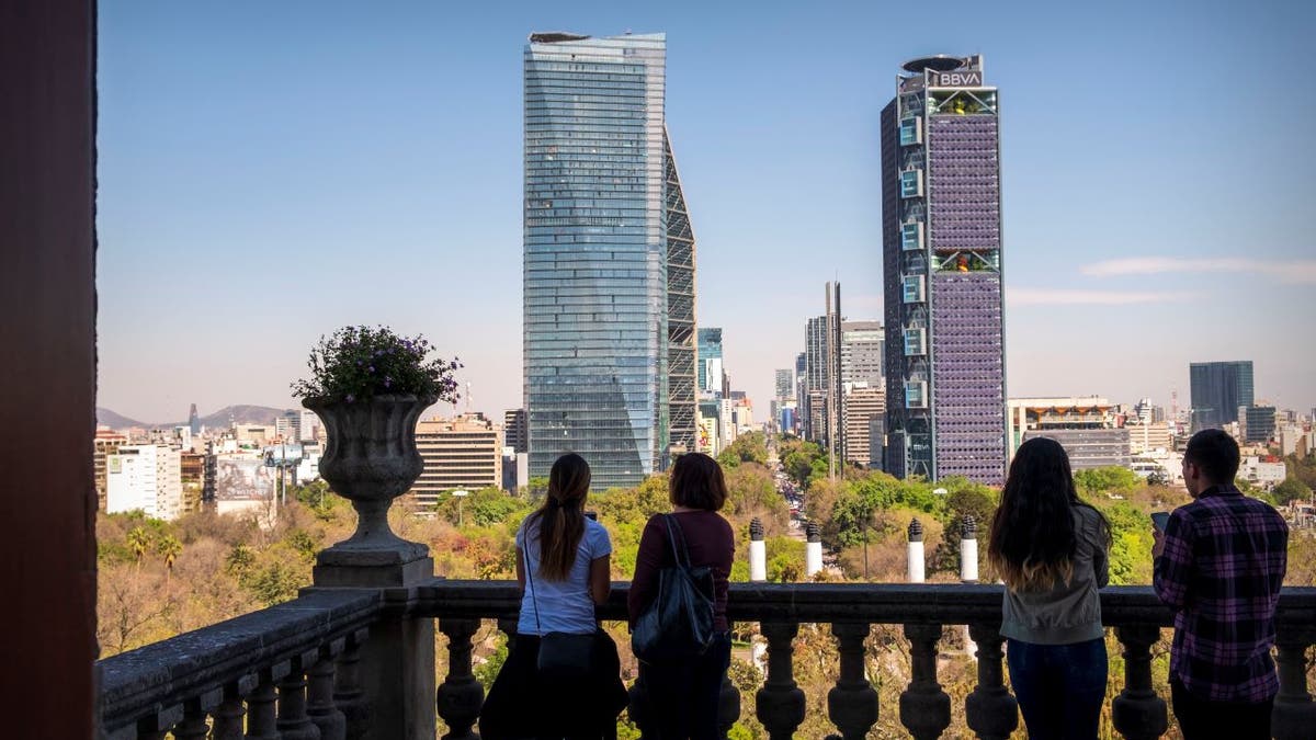 Daytime skyline of Mexico City with people in the foreground