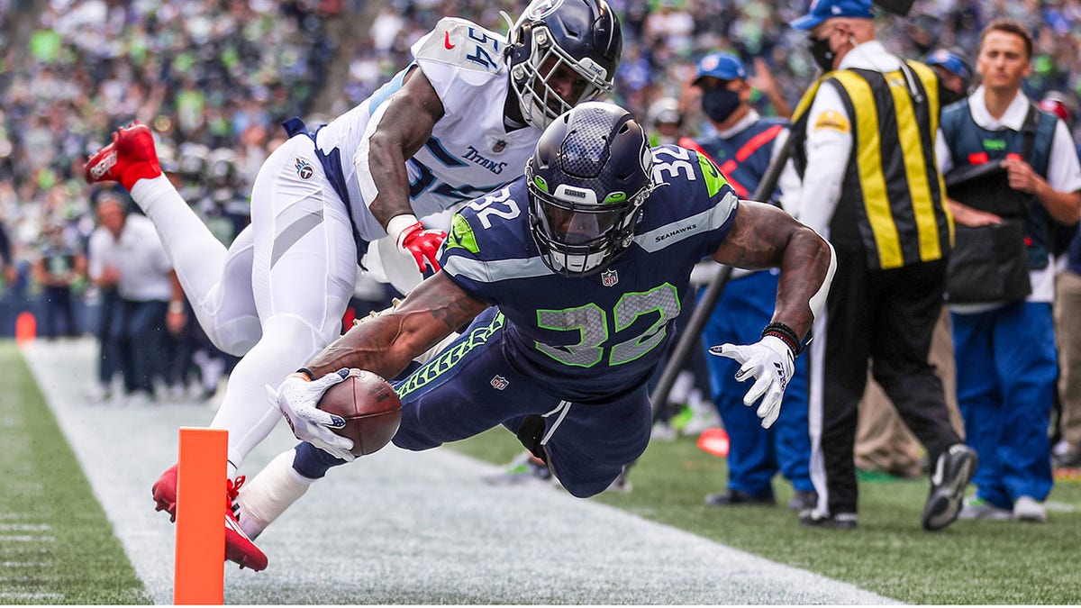 Chris Carson dives for the endzone against the Tennessee Titans
