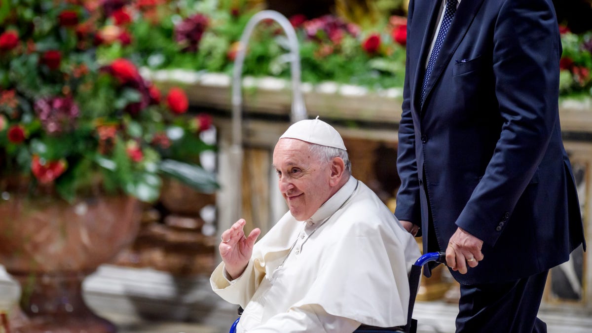 The pope waves at congregants