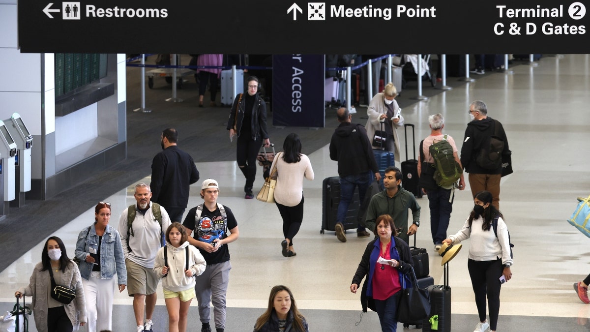 People walk through the San Francisco International Airport in July 2022.