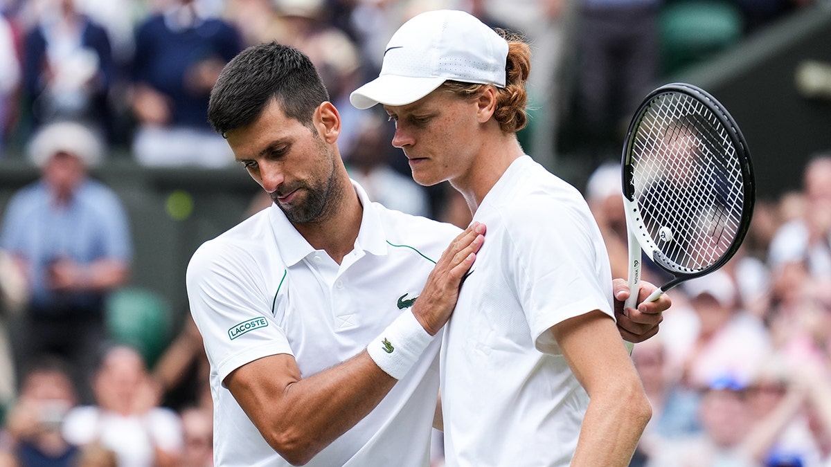 Novak Djokovic talks to Jannik Sinner after their match