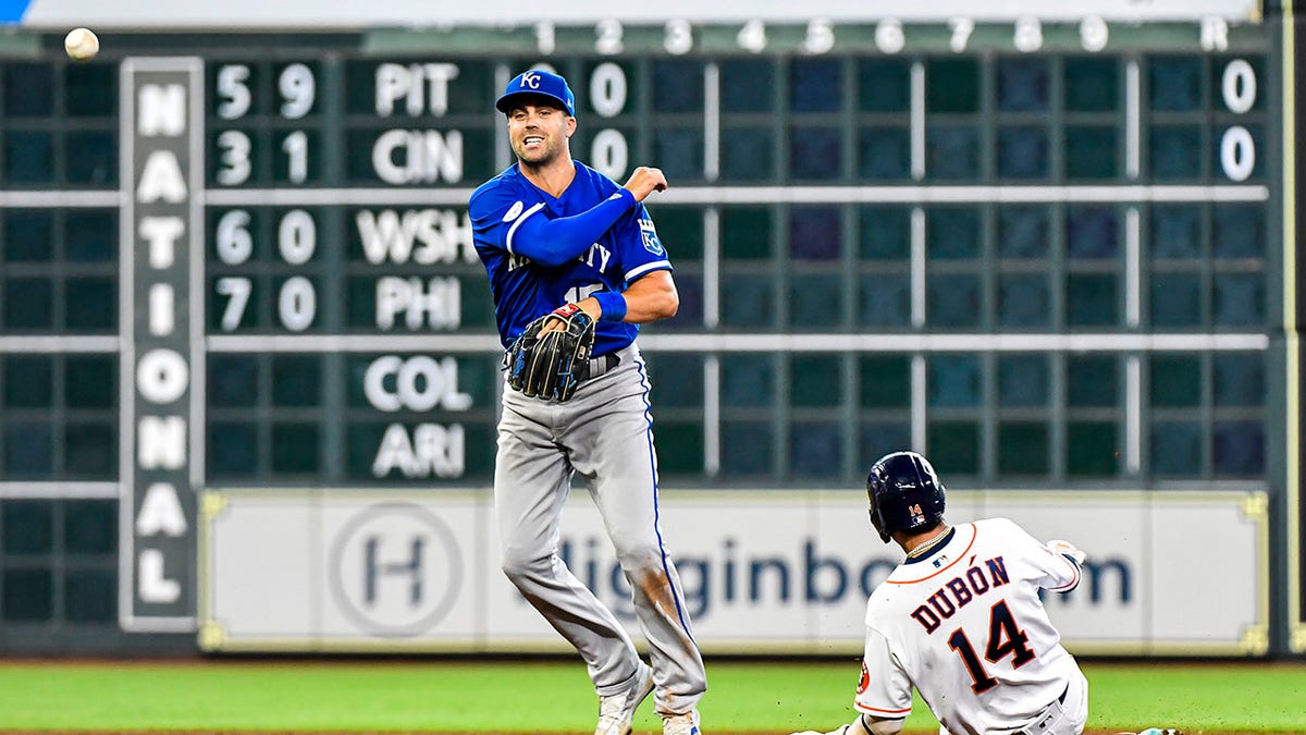 Whit Merrifield tries to turn a double play against the Houston Astros