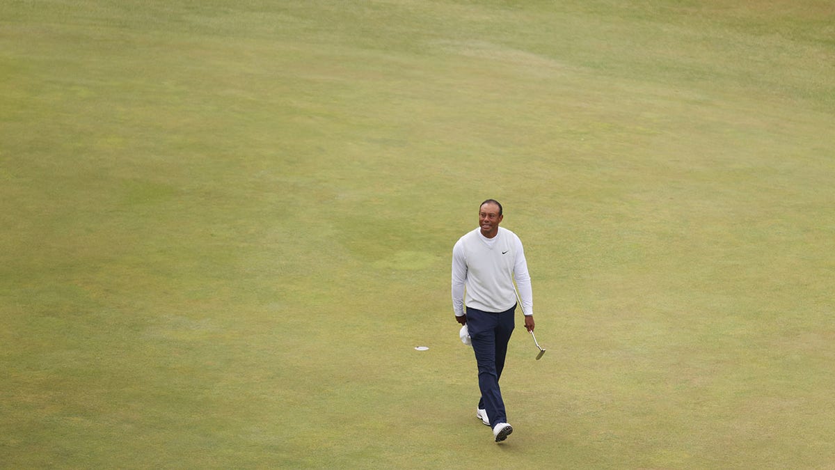 Tiger Woods takes a look at the crowd on the 18th green at The Open Championship