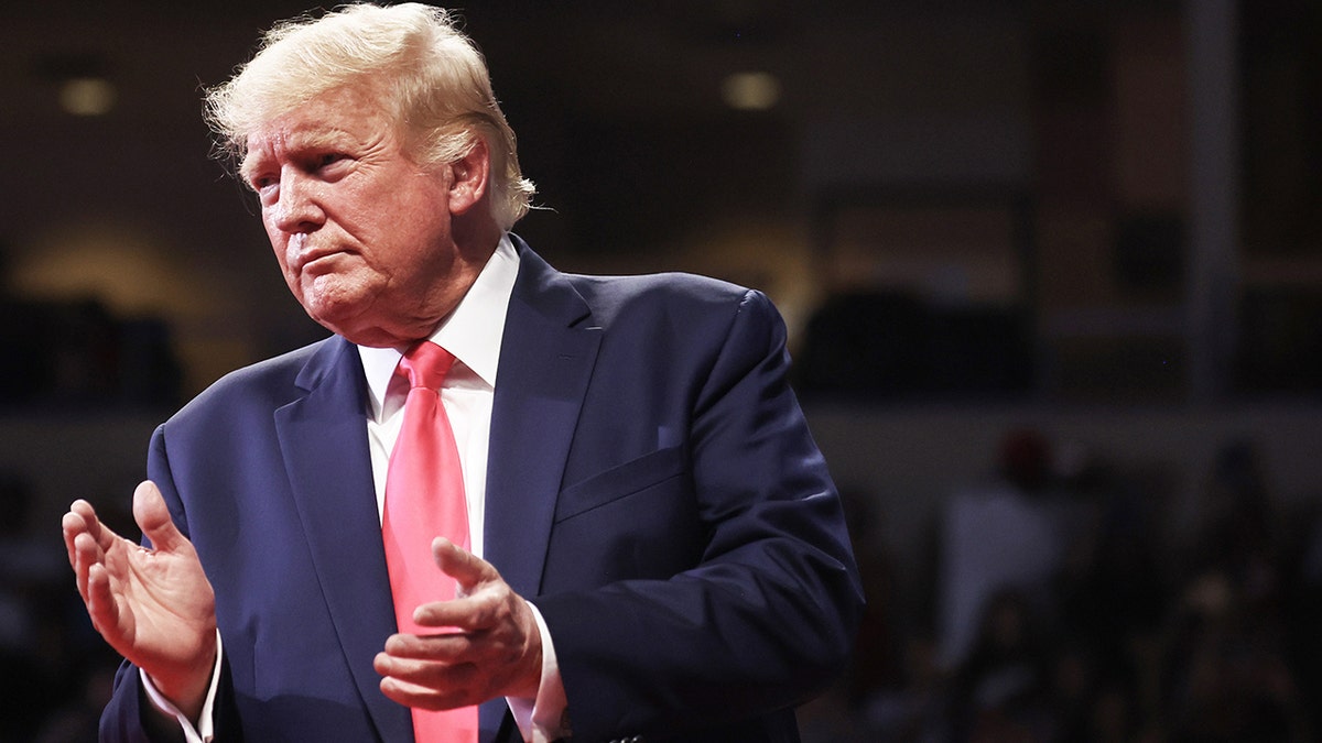 A photo of Trump clapping at the 'Save America' rally