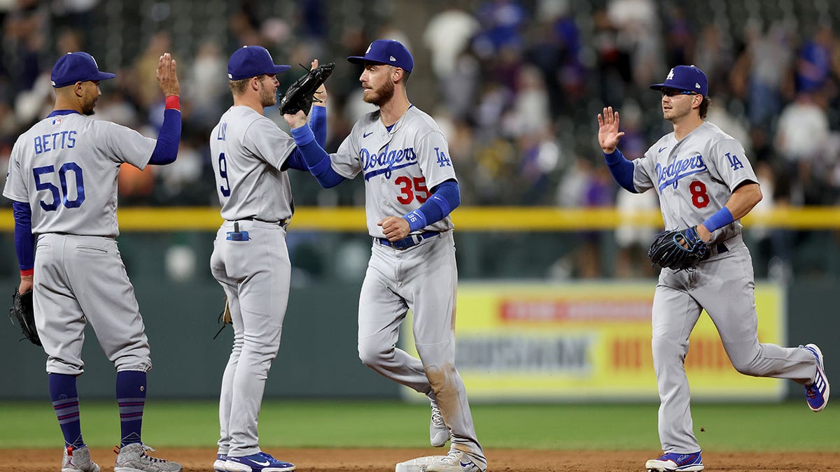 The Dodgers celebrate their 13-0 win over the Rockies