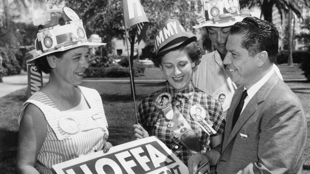 Jimmy Hoffa autographs a placard