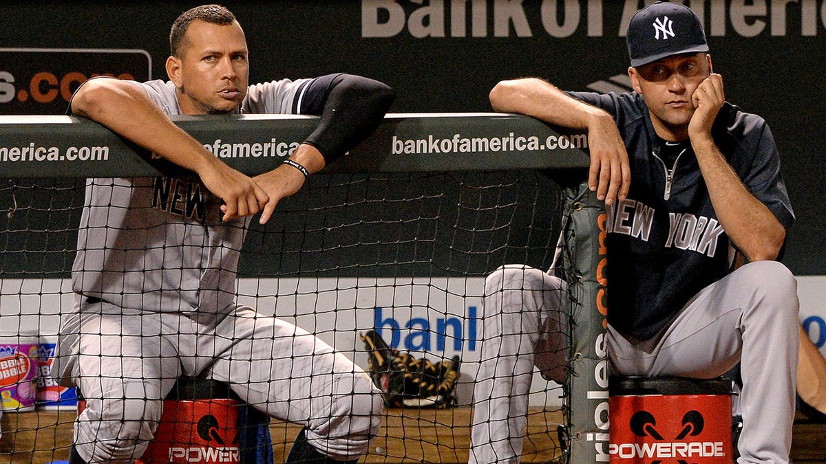 Derek Jeter and Alex Rodriguez look on during a 2013 game in Baltimore