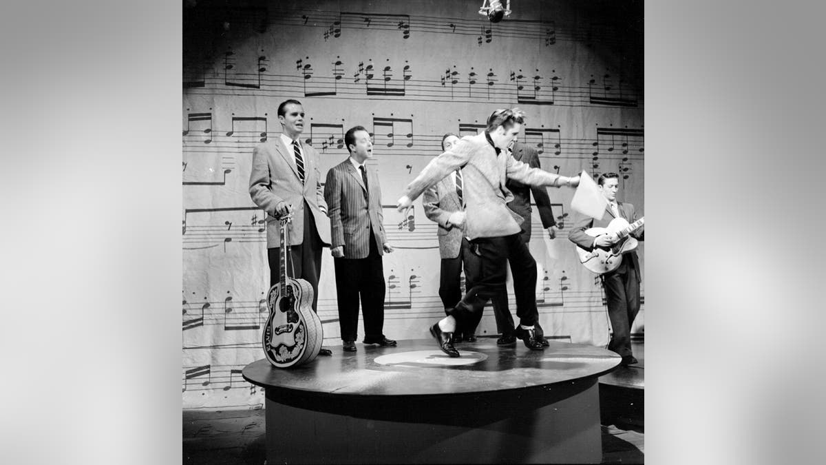 Elvis Presley wears suit during Ed Sullivan performance