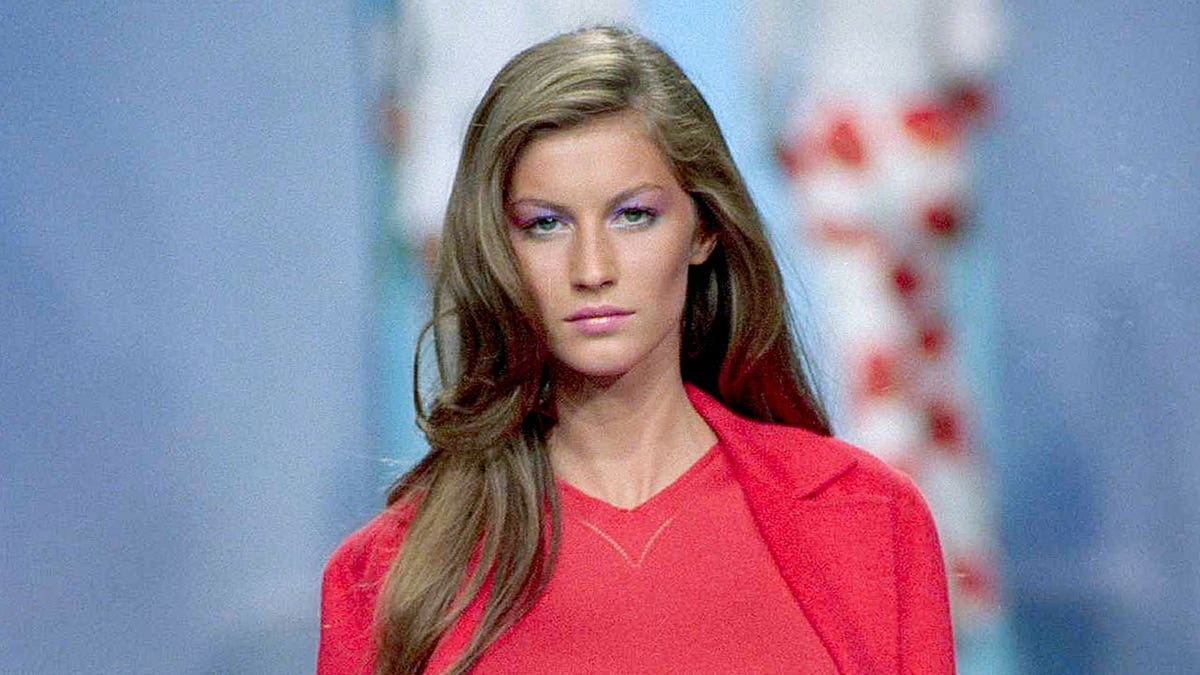 Gisele wears red blouse while walking runway in 1999