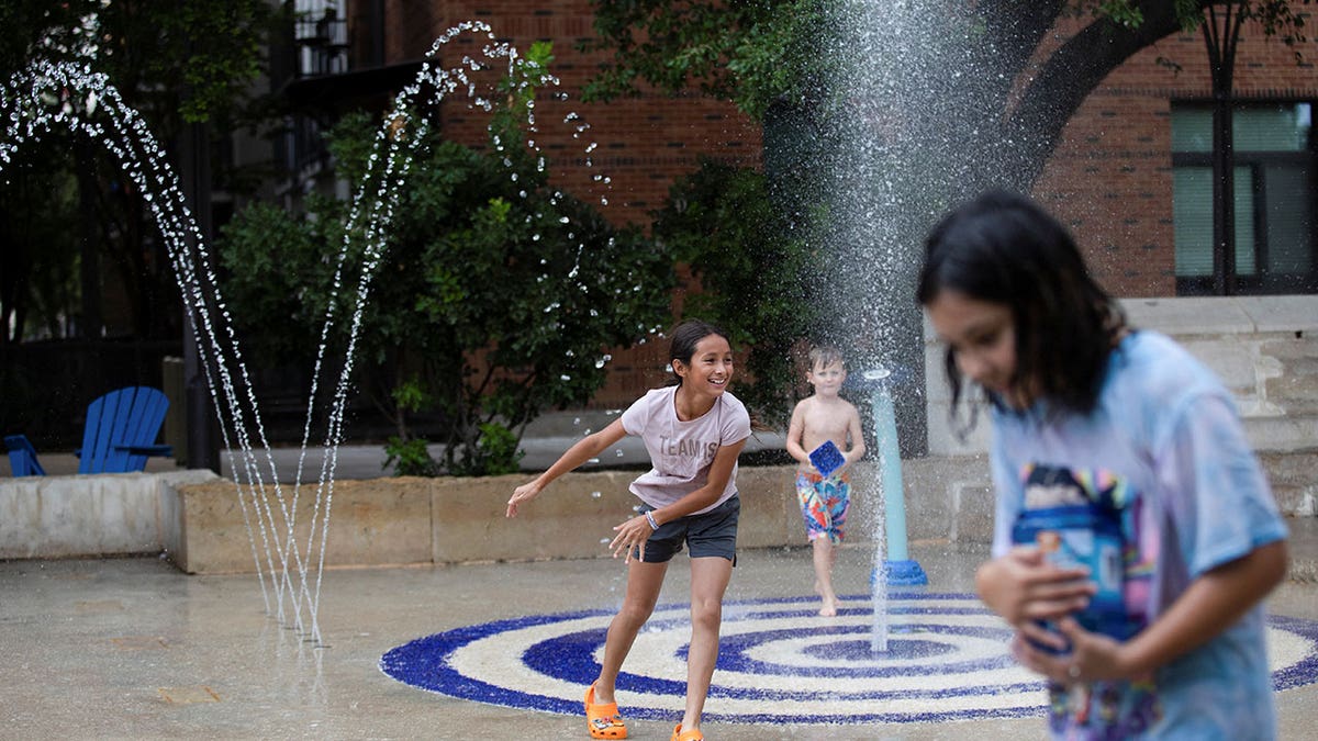 Children playing in fountain