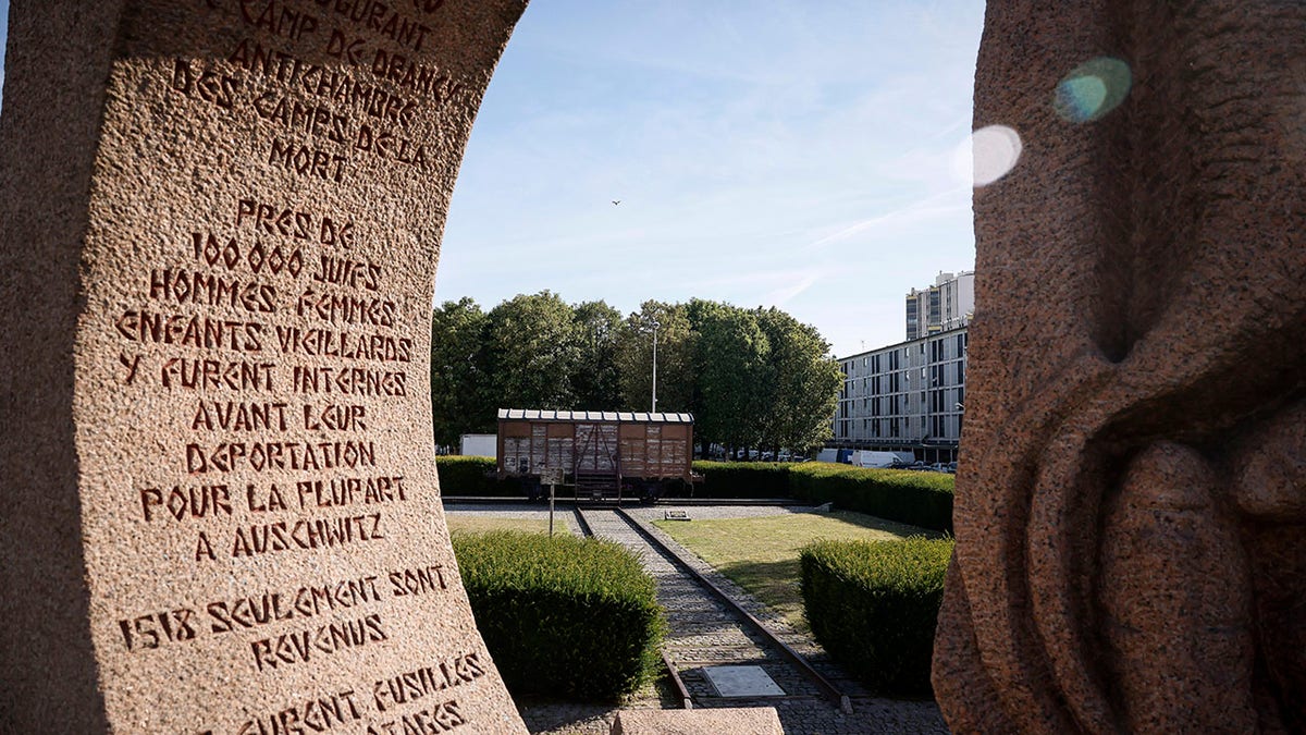 A memorial is pictured near a train car symbolizing the Drancy camp, at the Shoah memorial Tuesday, July 12, 2022 in Drancy, outside Paris. The Paris mayor and head of the French Holocaust Memorial will mark the 80th anniversary of the round-up of the Vel d'Hiv, the biggest Nazi roundup of Jews in France, visiting the site used as an internment camp during World War II for tens of thousands of people who were then sent on to Auschwitz and other death camps.
