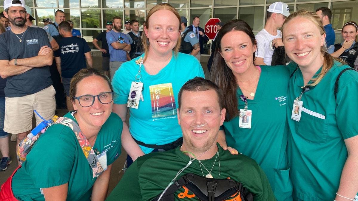 Chicago officer Danny Golden with nurses after he was paralyzed in a shooting.