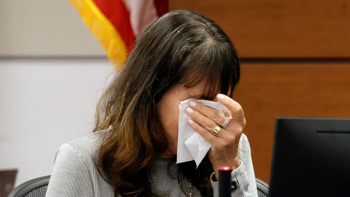 Ivy Schamis dabs her eyes with a tissue as she testifies about the murder of her two students