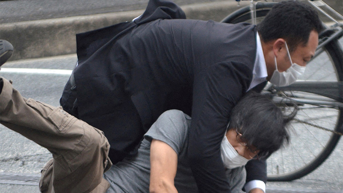 Shinzo Abe shooting suspect is taken down by a police officer