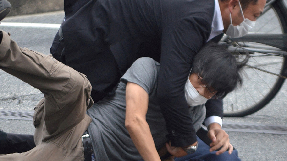 Shinzo Abe shooting suspect is taken down by a police officer