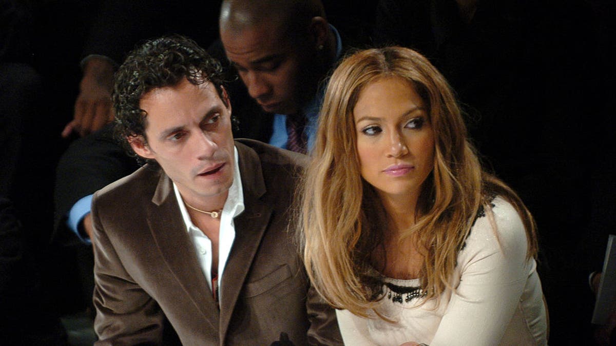 Jennifer Lopez and Marc Anthony at a fashion show.