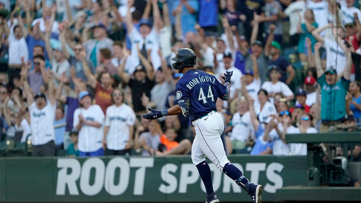 Julio Rodríguez celebrates as he rounds the bases