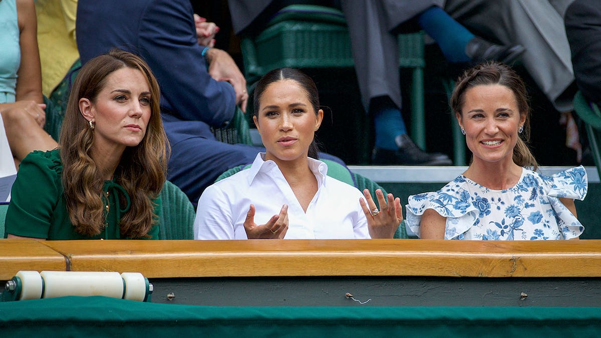 Kat e Middleton sitting next to Meghan Markle and her sister Pippa Middleton
