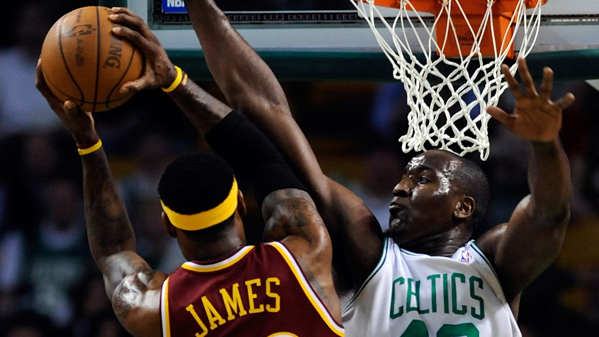 Kendrick Perkins tries to block LeBron James