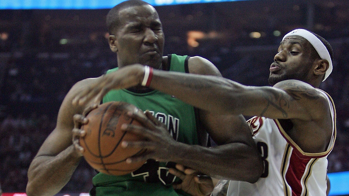 Kendrick Perkins drives on LeBron James