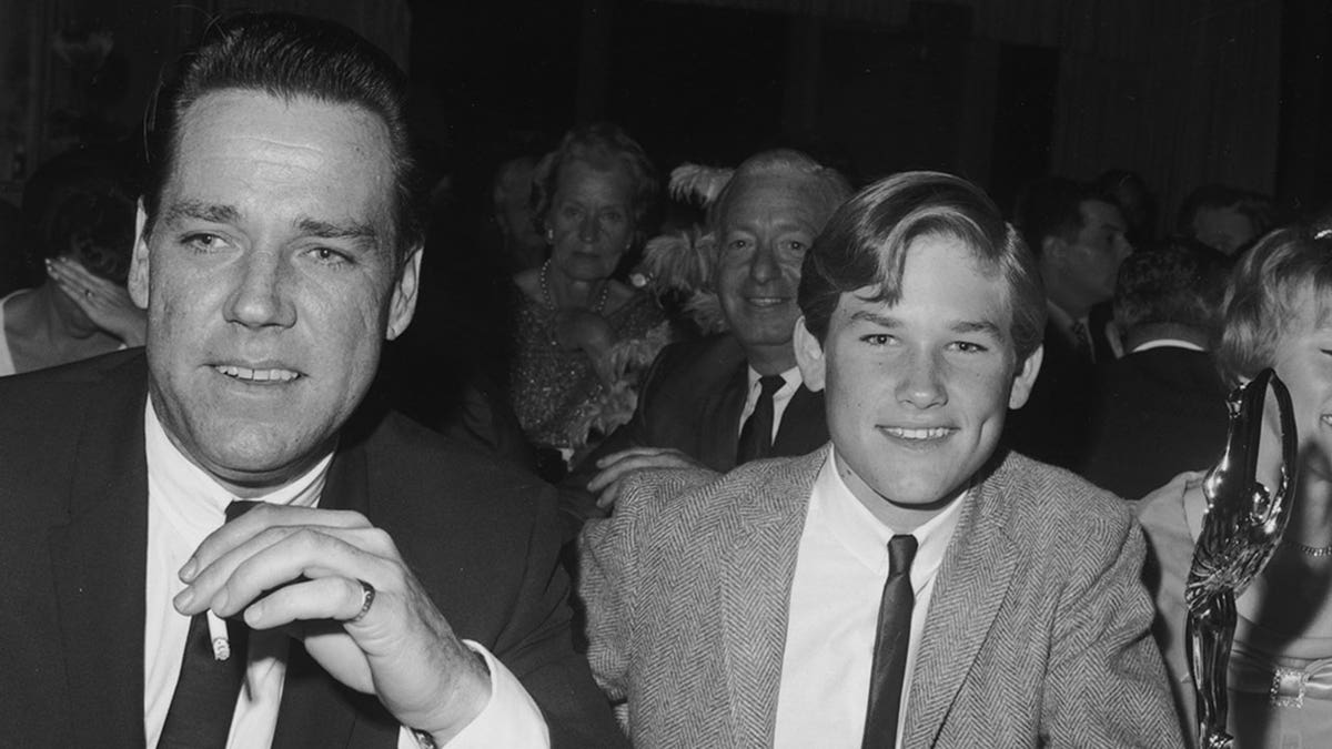 October 1966: American actor Kurt Russell (C) smiles at the Spotlighter Teen Awards dinner with his parents, Bing and Louise Russell. (Photo by Max B. Miller/Fotos International/Getty Images)