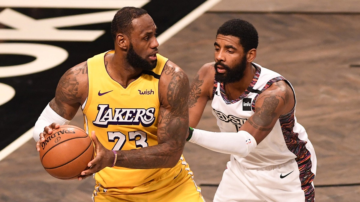 Kyrie Irving guards LeBron James