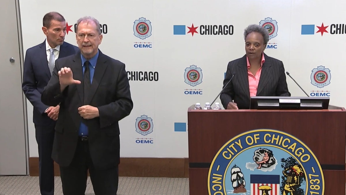 Chicago Mayor Lori Lightfoot in a suit behind a podium