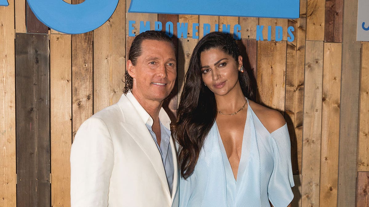 Matthew McConaughey wears white suit with Camila Alves blue dress