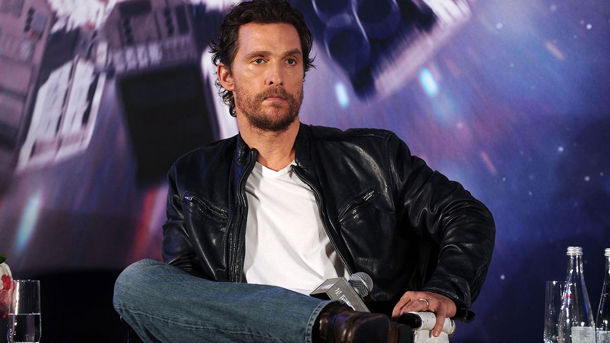 Matthew McConaughey sitting in a chair at a premiere