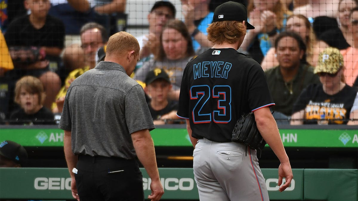 Max Meyer walks off mound with athletic trainer