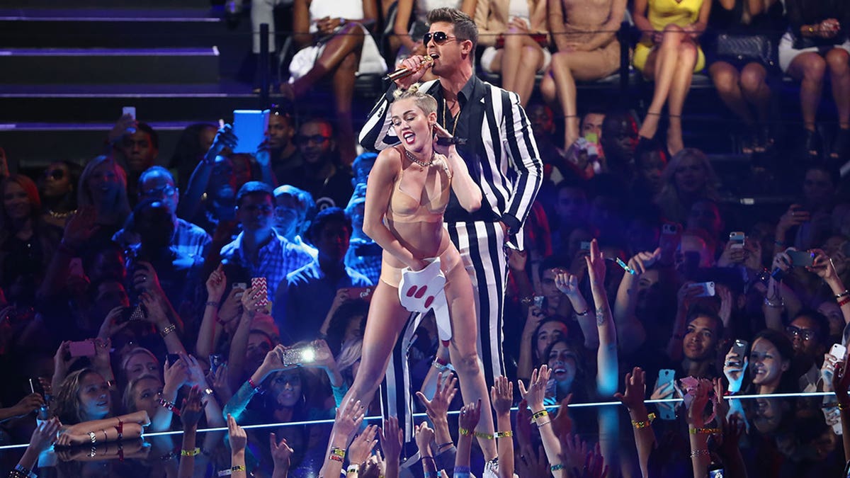 Miley Cyrus onstage with Robin Thicke